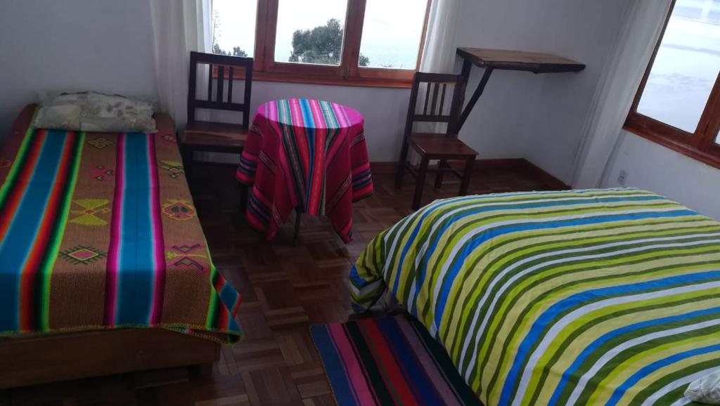 Postel nebo postele na pokoji v ubytování Hostal Inti Wayra