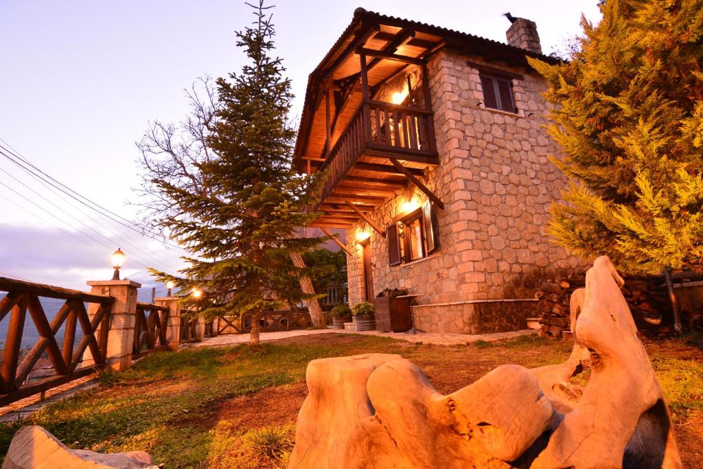 a house with a large rock in front of it at Filanthi in Kato Trikala Korinthias