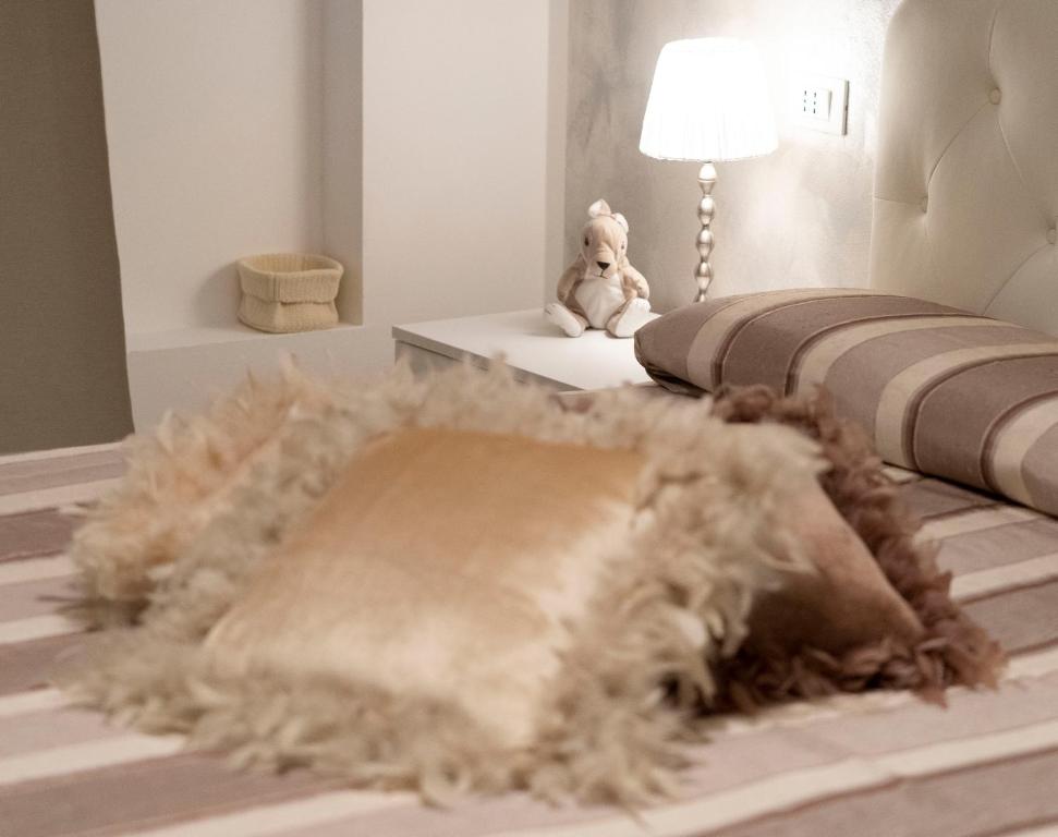 a teddy bear is sitting next to a bed at Nice & Cozy apartment in Venice