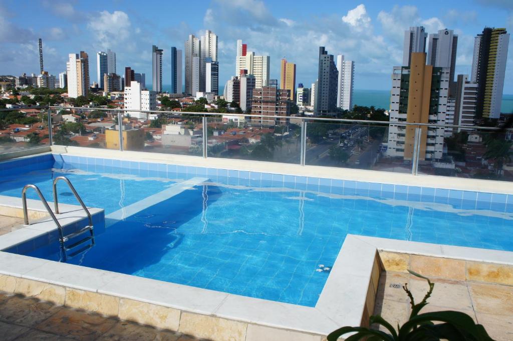 a swimming pool with a view of the city at Lindo flat sem custos adicionais in Natal