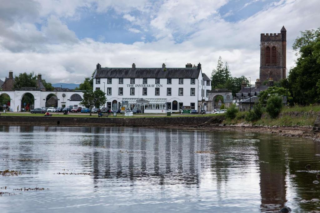 a large building with a clock on the side of it at The Inveraray Inn, BW Signature Collection in Inveraray