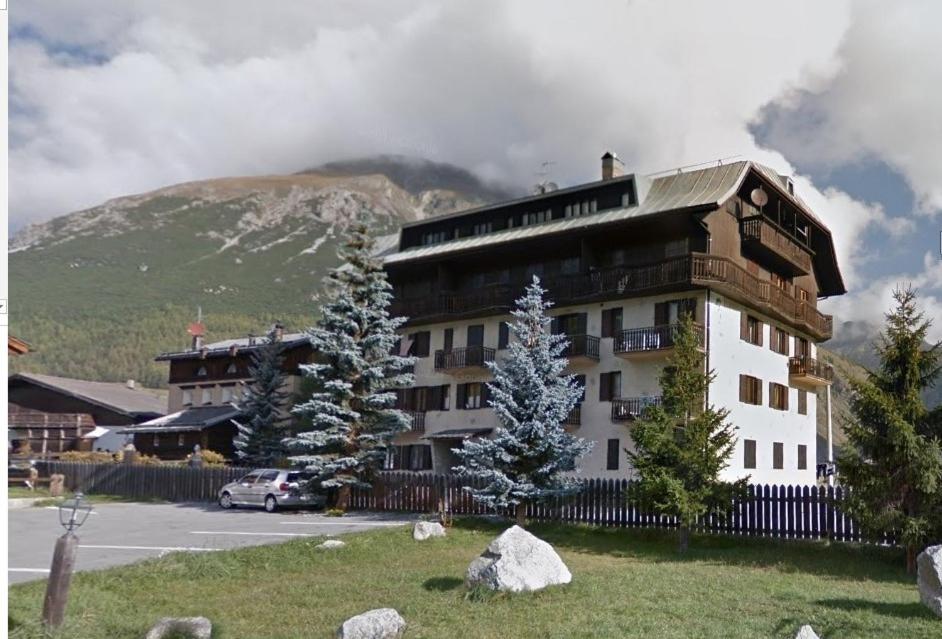 a large building in front of a mountain at White Edelweiss in Livigno