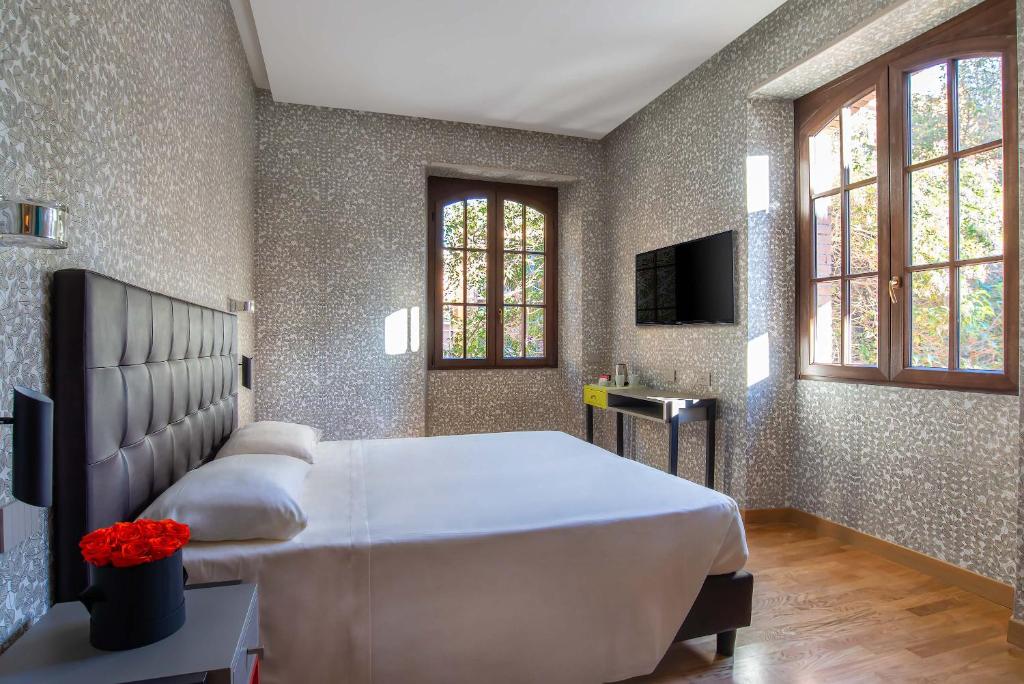 Uma cama ou camas num quarto em Albergo Etico Roma