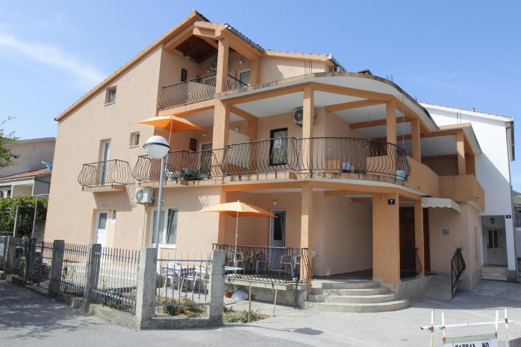 a large building with balconies on the side of it at Guest House Olga in Budva