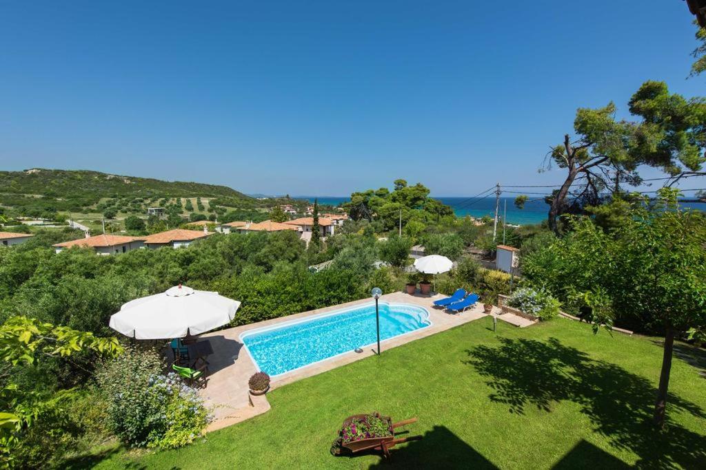 an image of a swimming pool in a yard at Villa Helios in Pefkochori