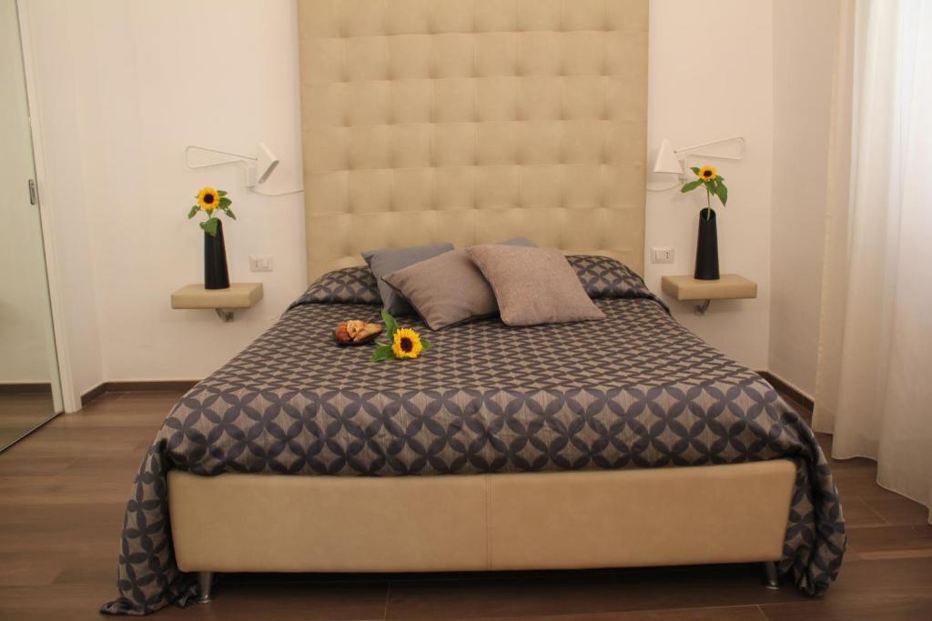 a bedroom with a large bed with a large headboard at B&B La Dimora in Corato