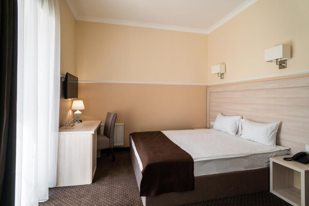 Postel nebo postele na pokoji v ubytování Potemkinn Hotel