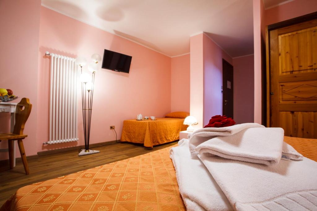 Postel nebo postele na pokoji v ubytování Hotel Olimpic