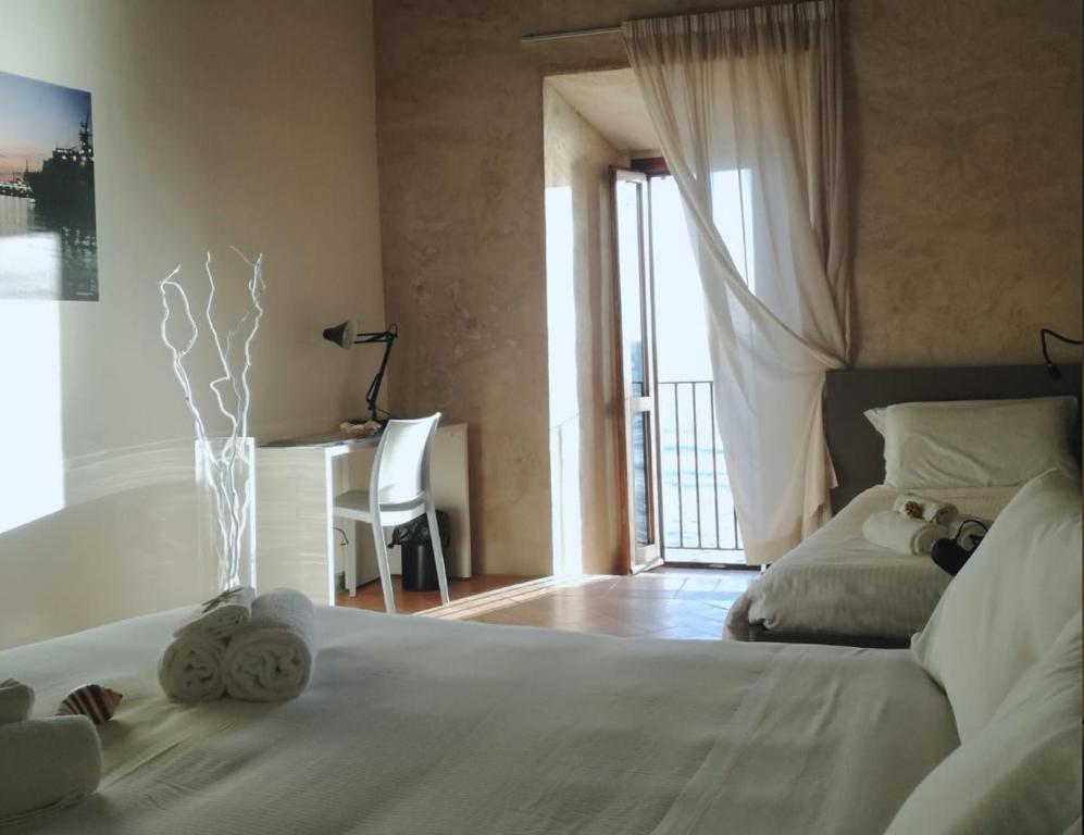 A bed or beds in a room at Ostello del Castello di Santa Severa