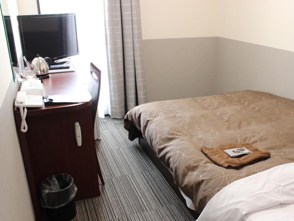 Postel nebo postele na pokoji v ubytování Natural SPA, Kanazawa Hotel Yumenoyu