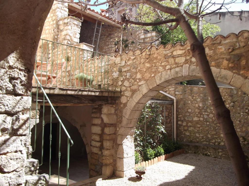une arche dans un bâtiment en pierre avec un escalier dans l'établissement L' ensoleilladou, à Quinson