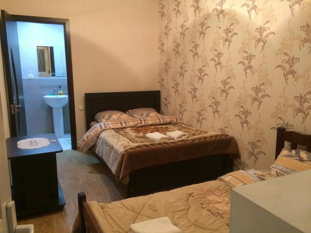 Postel nebo postele na pokoji v ubytování Guest House Loza