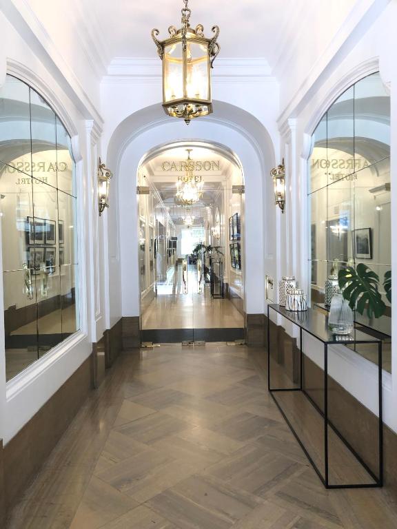 a hallway of a store with windows and a chandelier at Carsson Hotel Downtown Buenos Aires in Buenos Aires