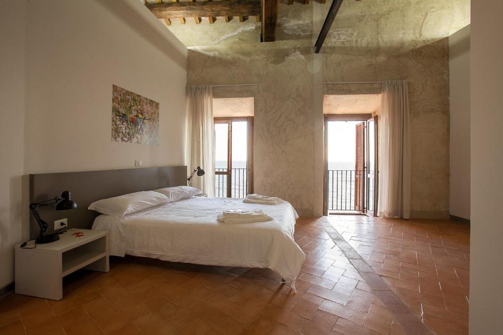 A bed or beds in a room at Ostello del Castello di Santa Severa