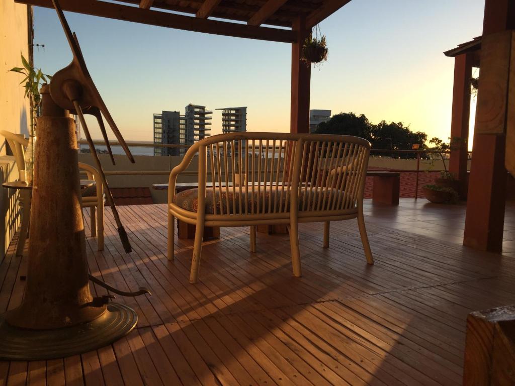 un banc en bois installé au-dessus d'une terrasse dans l'établissement The Base Backpackers, à Maputo