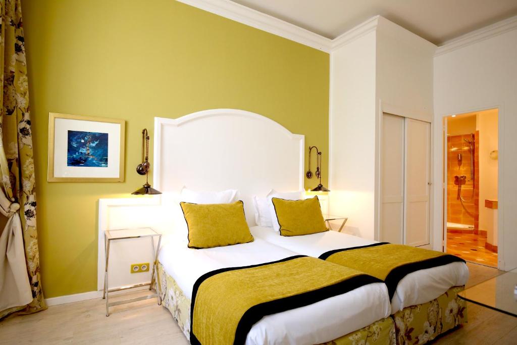 Postel nebo postele na pokoji v ubytování Hotel Royal Bon Repos