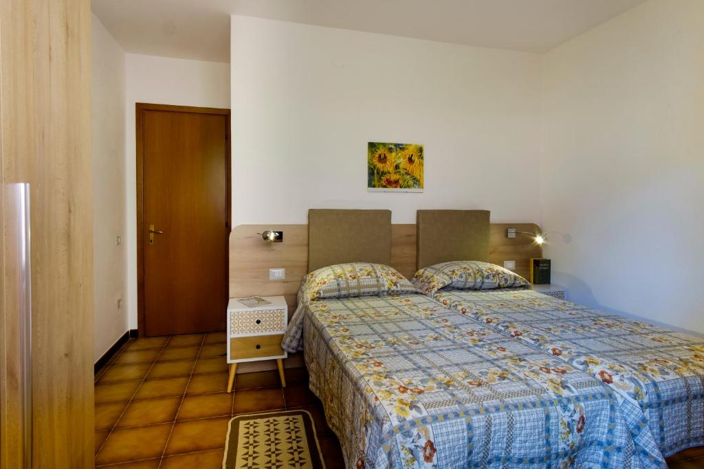 Postel nebo postele na pokoji v ubytování Residence Appartamenti Caffarena
