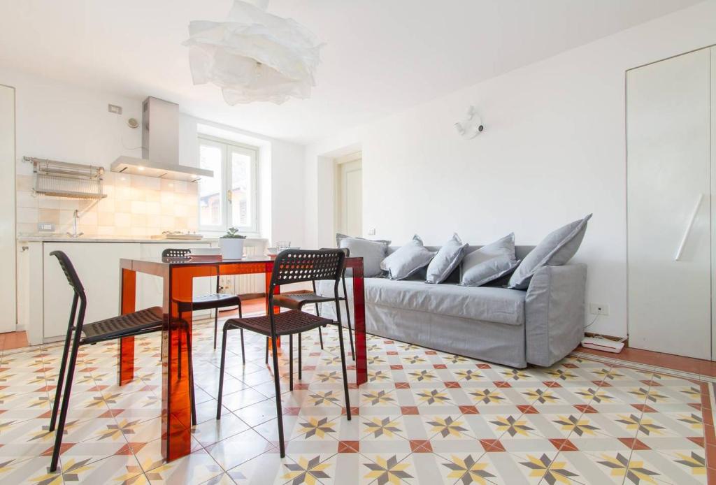 a living room with a couch and a table and chairs at Papavero Accademia Carrara in Bergamo