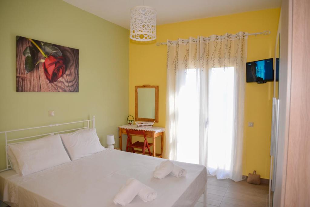 A bed or beds in a room at Andri House