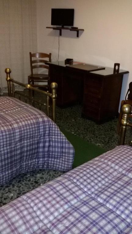 Łóżko lub łóżka w pokoju w obiekcie B&B Metropolitan Taranto