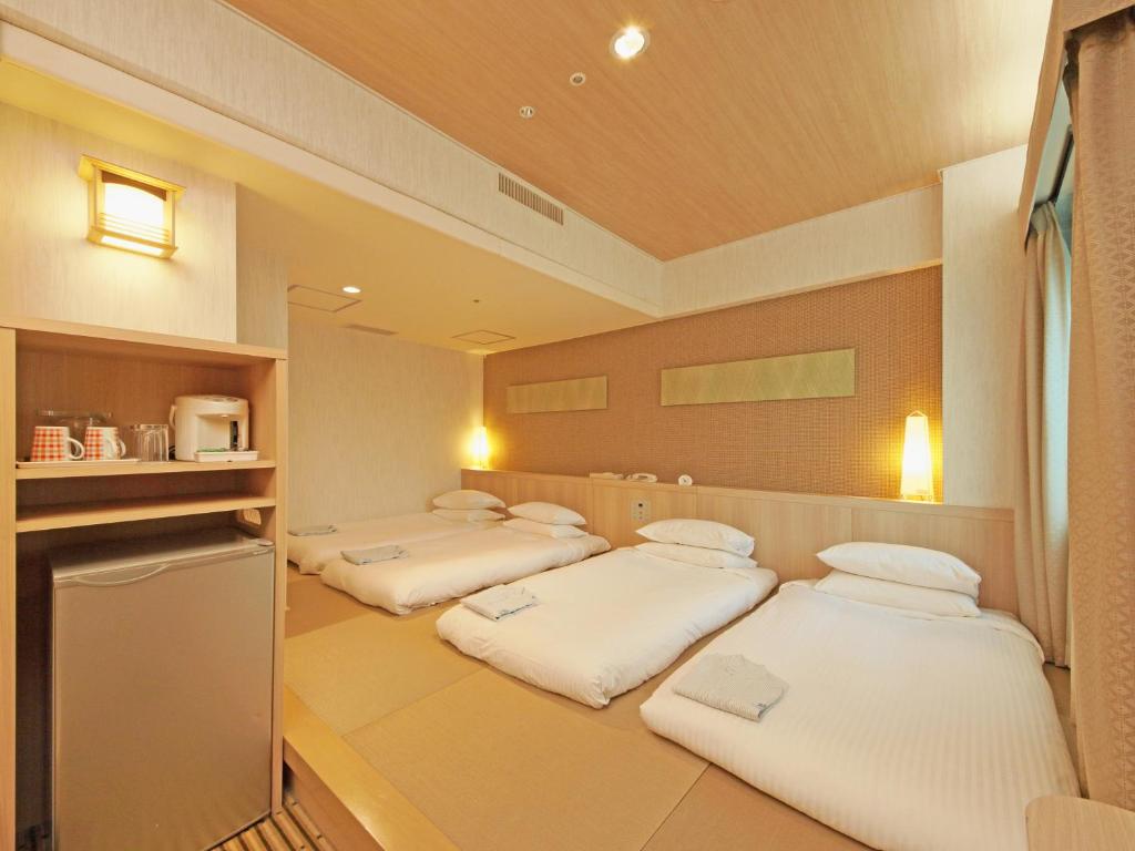 Postel nebo postele na pokoji v ubytování Hotel Nikko Narita