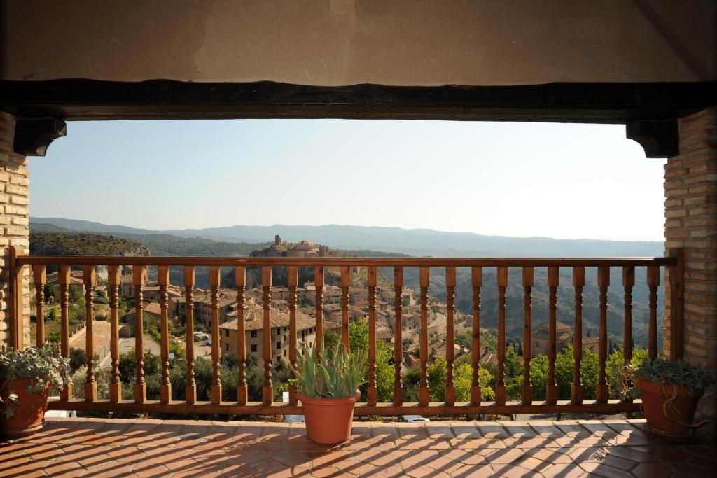 a balcony with potted plants and a view at Albergue Rural de Guara in Alquézar
