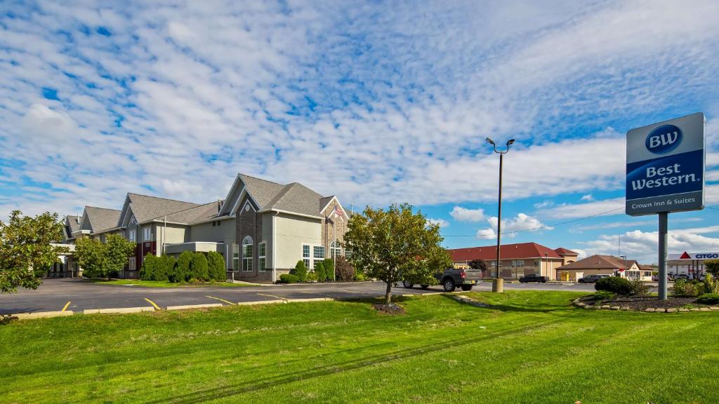 a best western sign in front of a house at Best Western Crown Inn & Suites - Batavia in Batavia