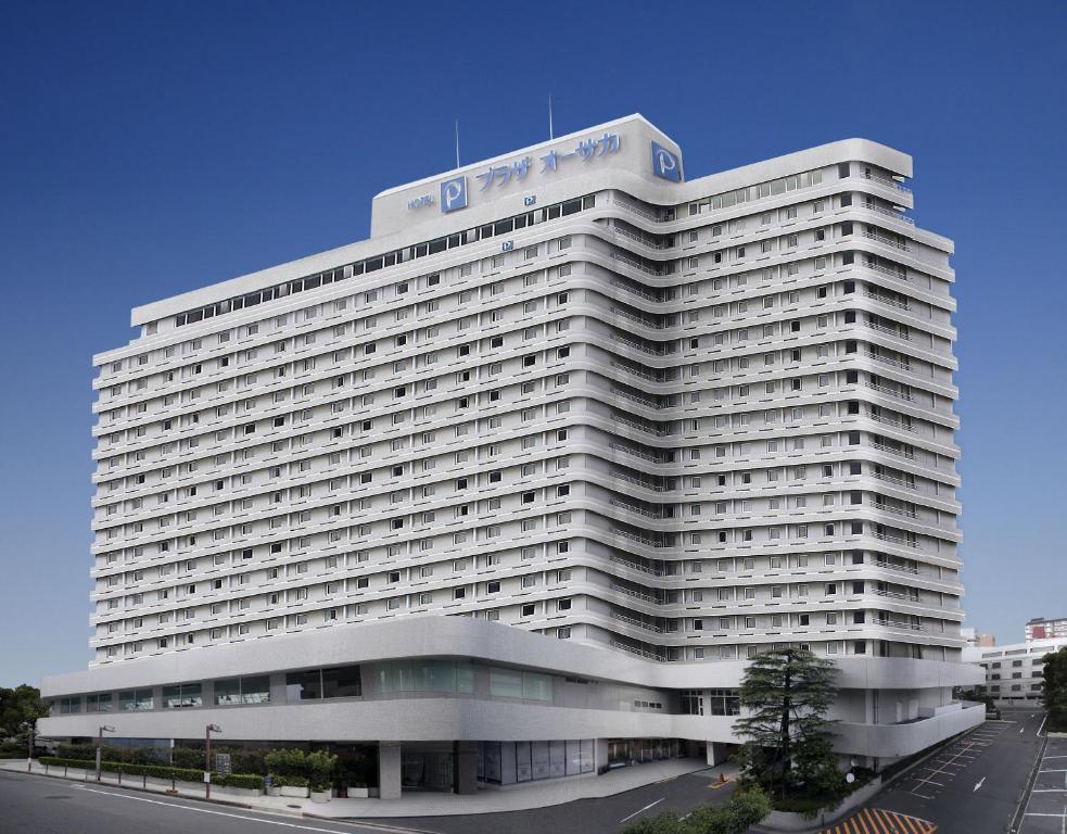 a large white building with a sign on top of it at Hotel Plaza Osaka in Osaka