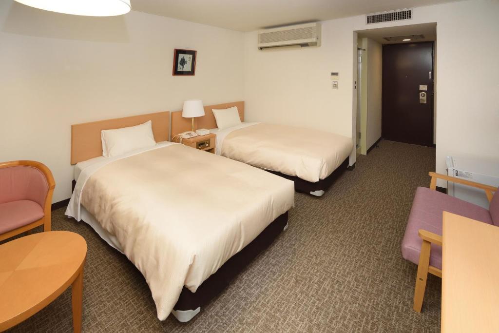 Postel nebo postele na pokoji v ubytování Hotel Route Tsukuba