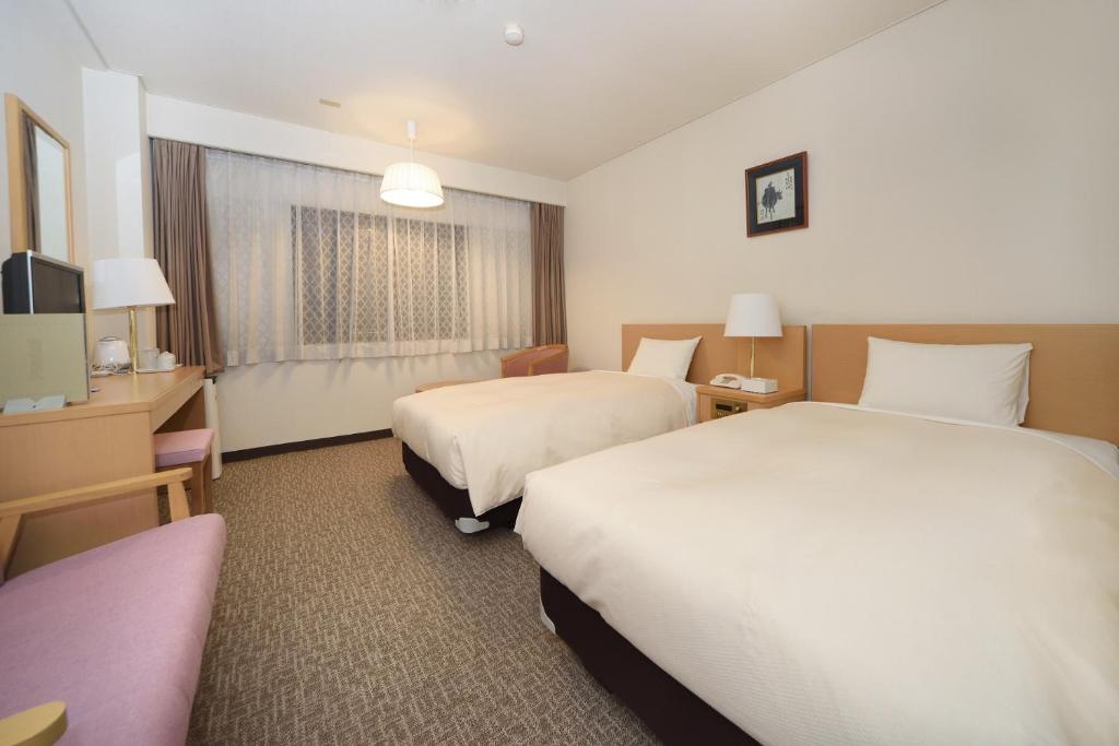 Postel nebo postele na pokoji v ubytování Hotel Route Tsukuba