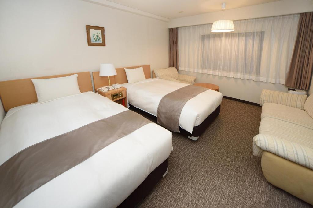 Postel nebo postele na pokoji v ubytování Hotel Route Tsukuba