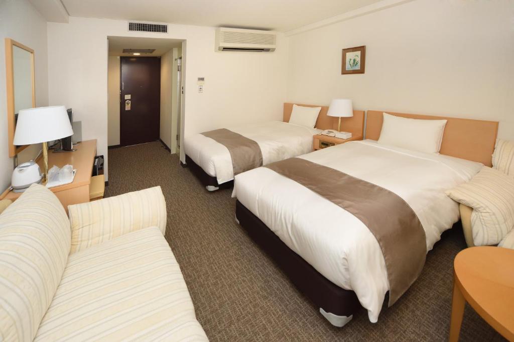 Ліжко або ліжка в номері Hotel Route Tsukuba