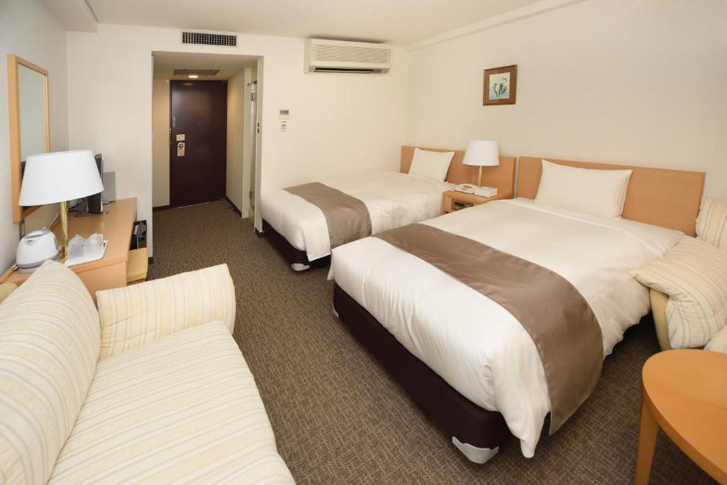 Postel nebo postele na pokoji v ubytování Hotel Route Tsukuba