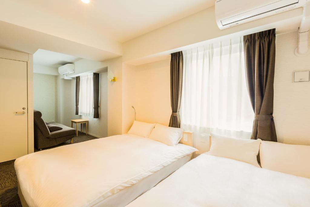 Hotel Ninestates Hakata tesisinde bir odada yatak veya yataklar