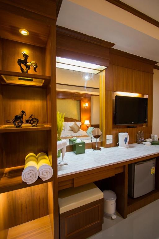 Habitación con cama y escritorio con toallas. en The Lion King Hotel Udonthani, en Udon Thani