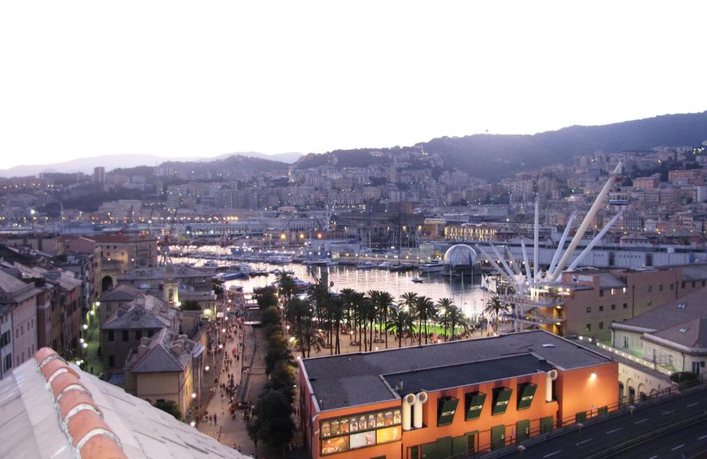 a view of a city with a river and buildings at aquarium rooms in Genoa