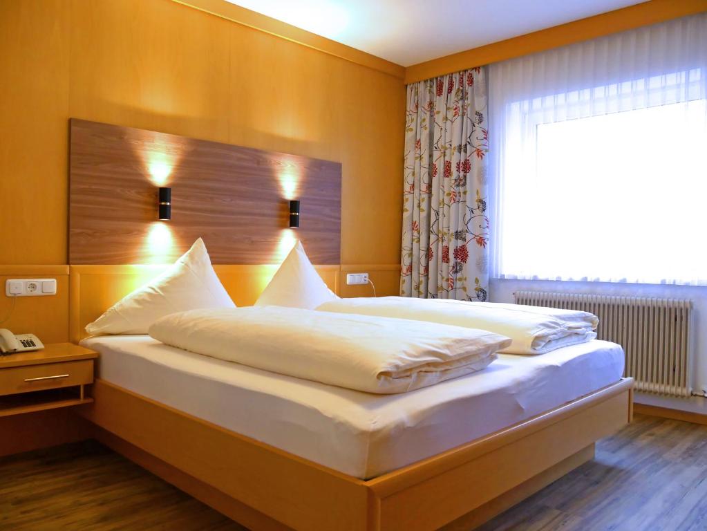 Postel nebo postele na pokoji v ubytování Hotel Grieserhof