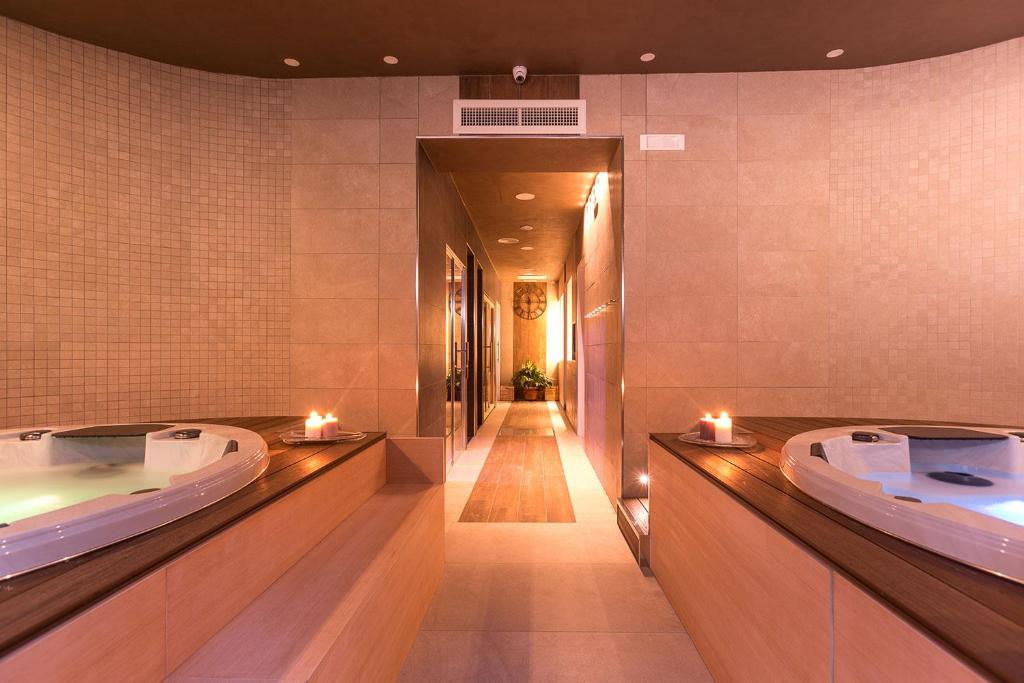 a bathroom with two jacuzzi tubs with candles in it at Dal Patricano in Frosinone