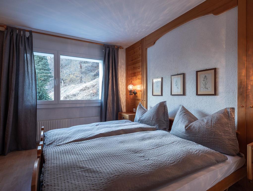 Postel nebo postele na pokoji v ubytování Malteserhaus Zermatt