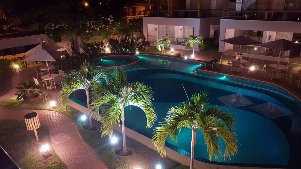 an overhead view of a swimming pool at night at Solaris Forever in Imbassai