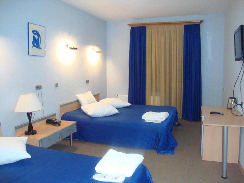 Postel nebo postele na pokoji v ubytování Hotel Villa Palace