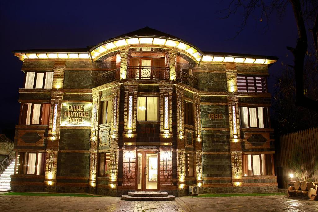 an old building with lights on it at night at MinAli Boutique Hotel in Sheki