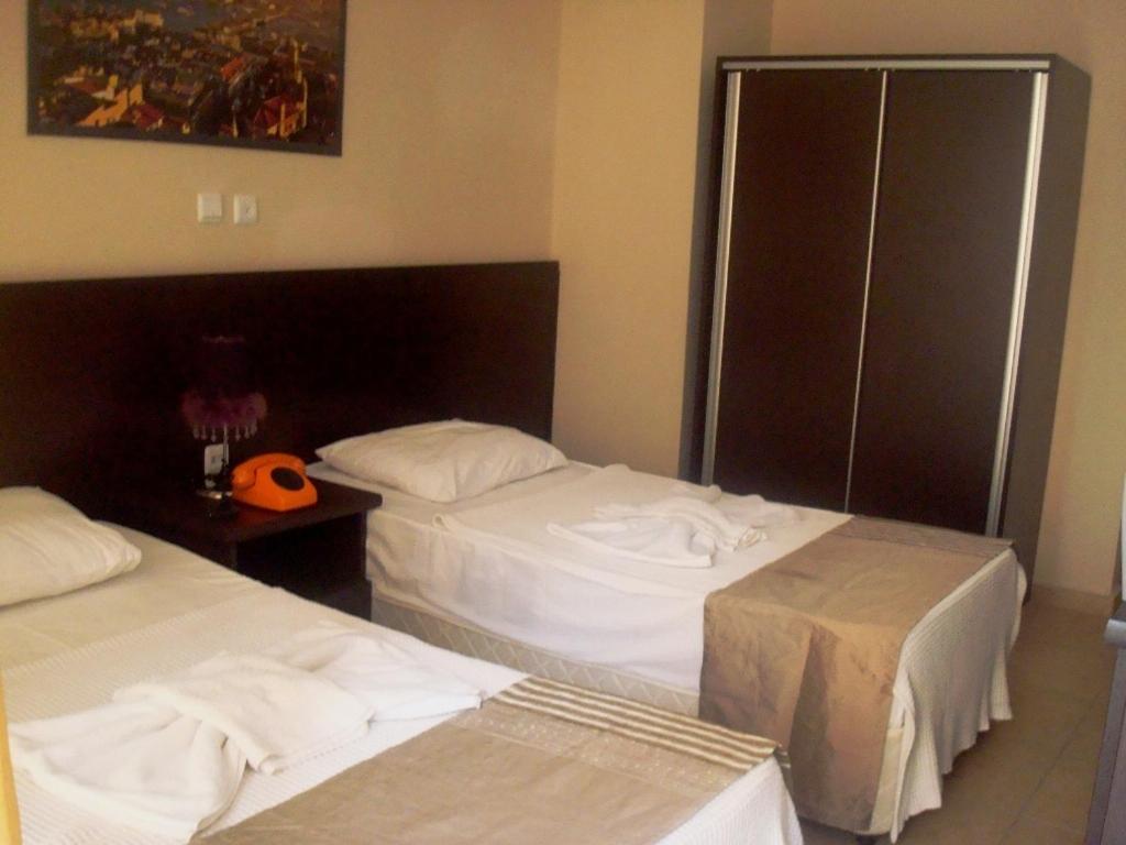 Postel nebo postele na pokoji v ubytování Kartel Hotel