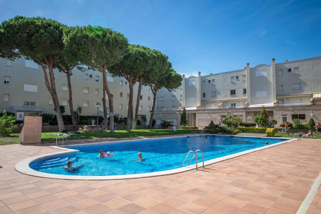 um grupo de pessoas em uma piscina em um edifício em Apartment Elena em L'Escala