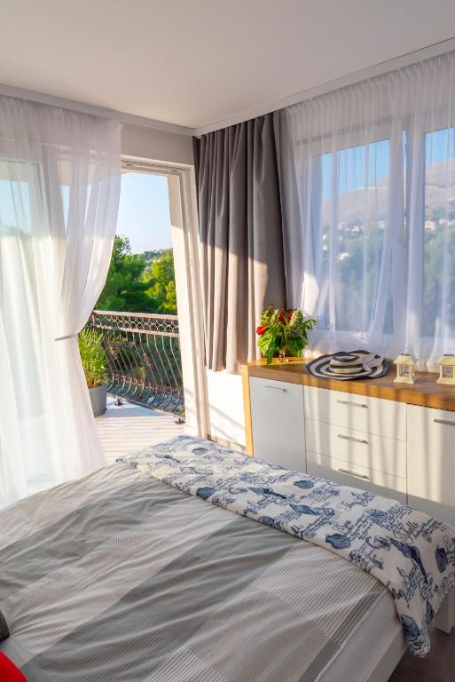 Postel nebo postele na pokoji v ubytování Apartmani Dalmacjia