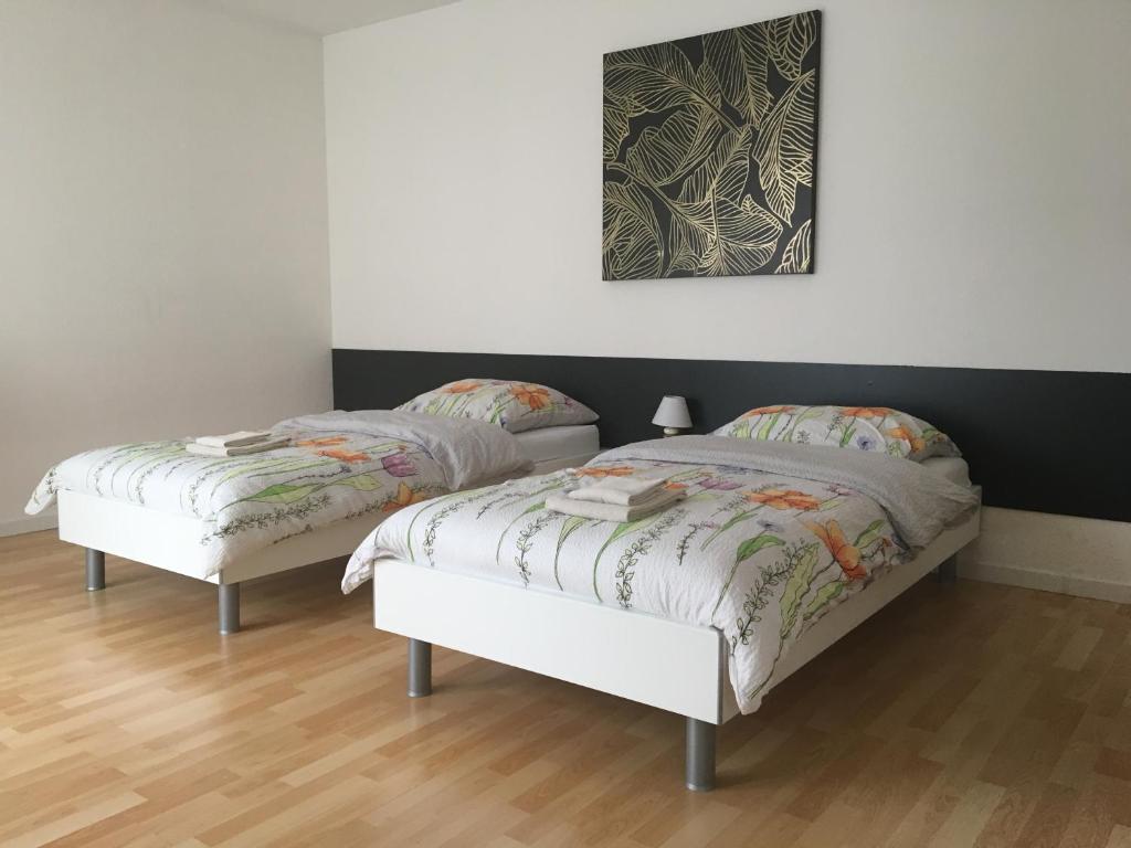 two beds sitting next to each other in a room at Studio Lora S 101 in Saint-Louis