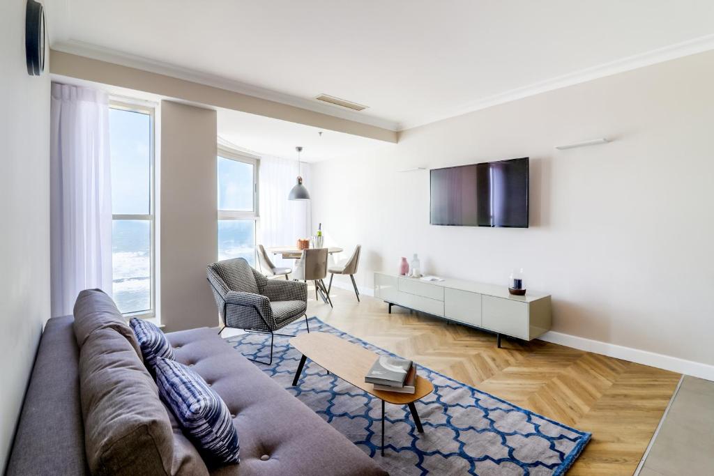 a living room with a couch and a table at master Haifa Beach Apartments in Haifa