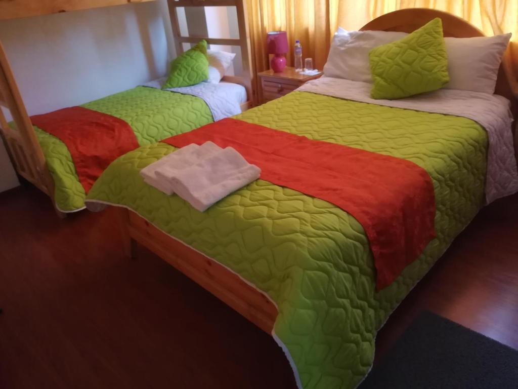 Postel nebo postele na pokoji v ubytování Hostal Alborada Riobamba