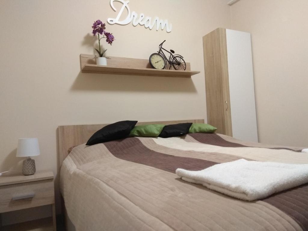 ハイドゥソボスローにあるDream Lux Apartmanのベッドルーム1室(ベッド2台、壁掛け時計付)