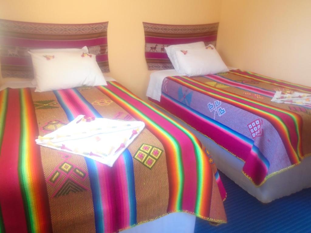 Una cama o camas en una habitación de Quillapata Lodge